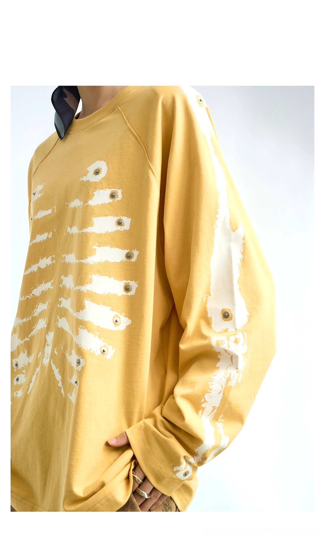 Skeleton print cotton raglan long sleeve streetwear top showing its relaxed silhouette and bold graphic design