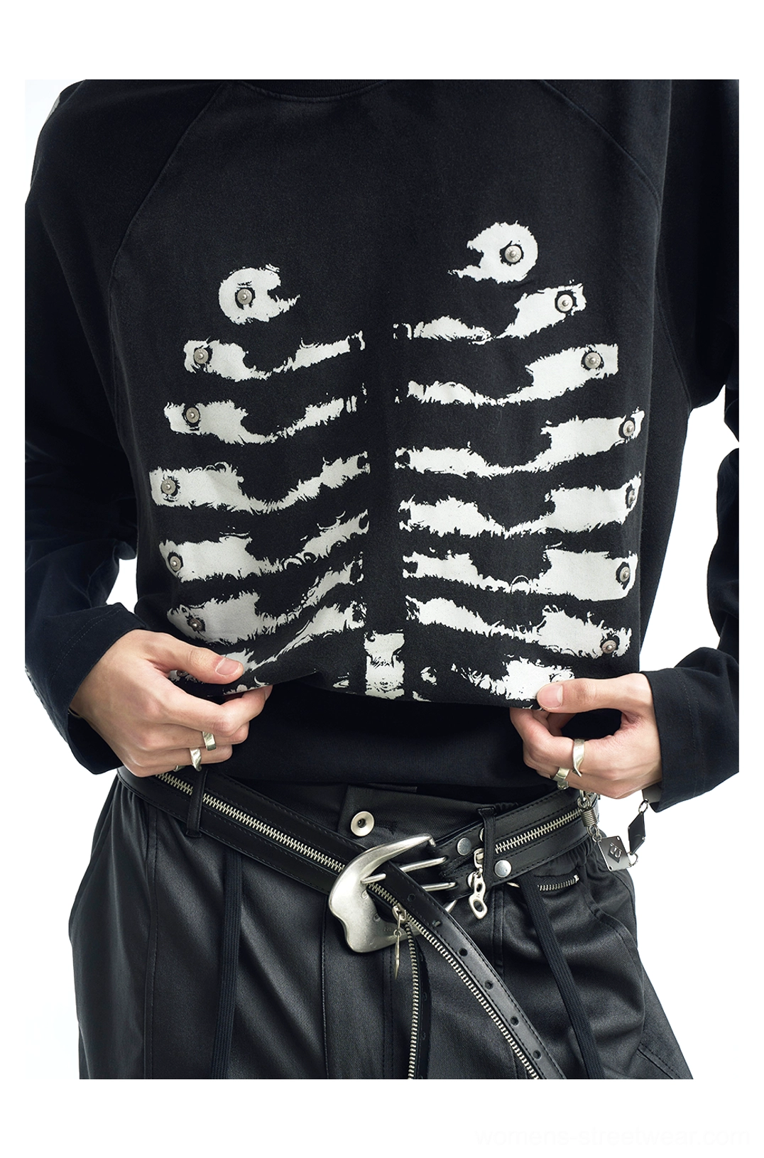 Close-up front view of black skeleton graphic streetwear shirt showing the detailed white ribcage print and crew neckline