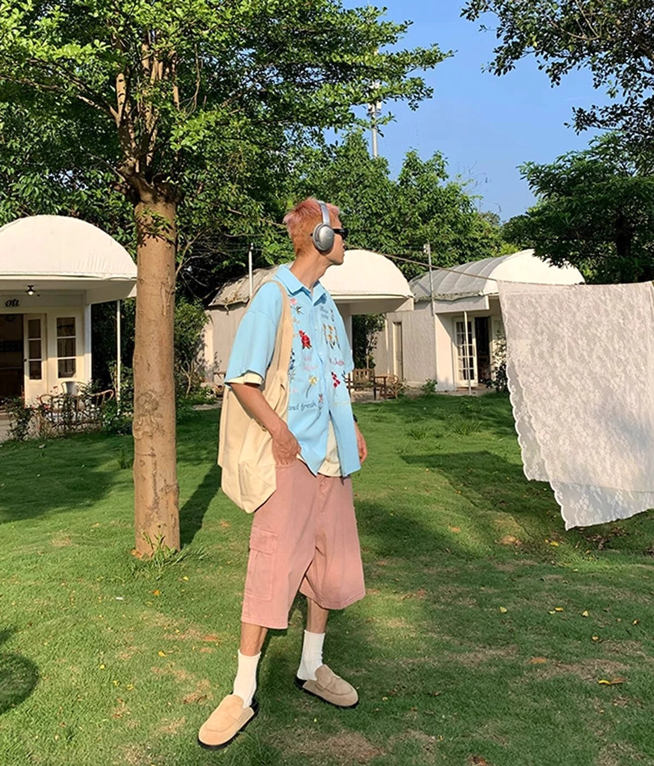 Side view of sky blue embroidered floral short sleeve shirt with boxy fit and colorful details for casual streetwear styling