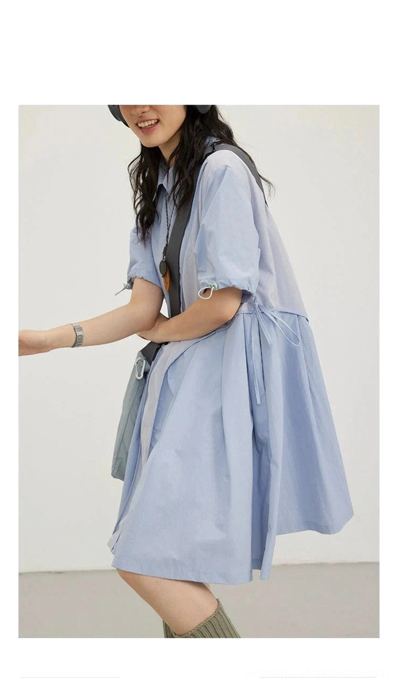 Side view of a sky blue oversized mesh-paneled shirt dress with adjustable drawstring detail and crossbody bag