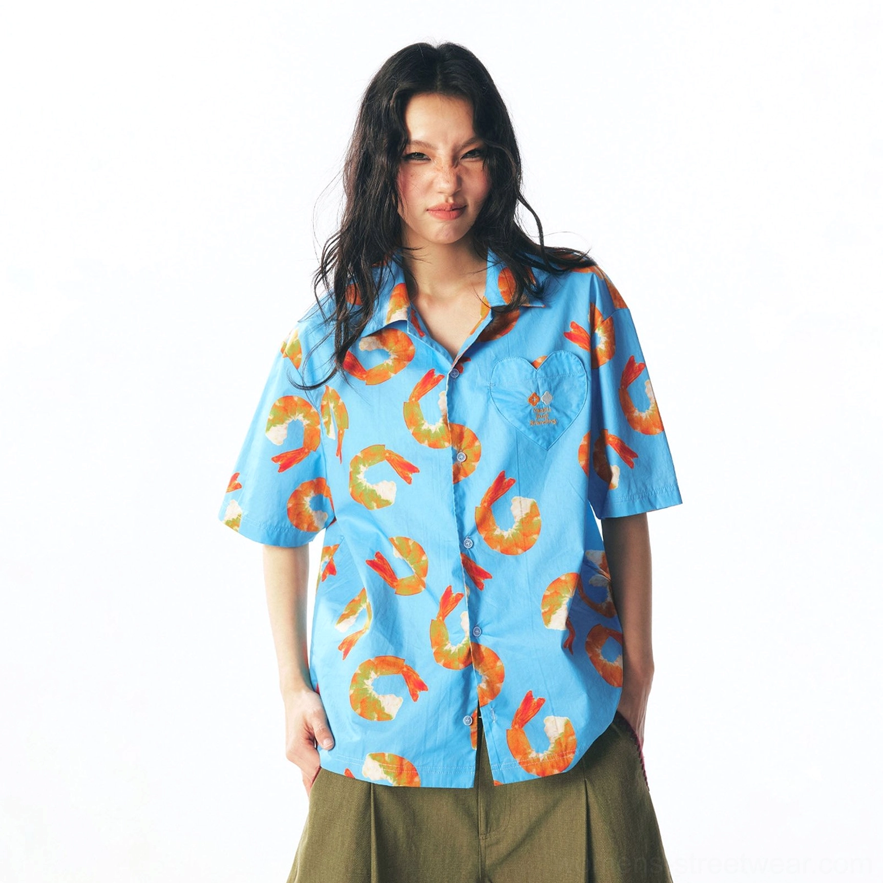Front full-body view of sky blue shrimp print short-sleeve streetwear button shirt styled with olive wide-leg cropped pants