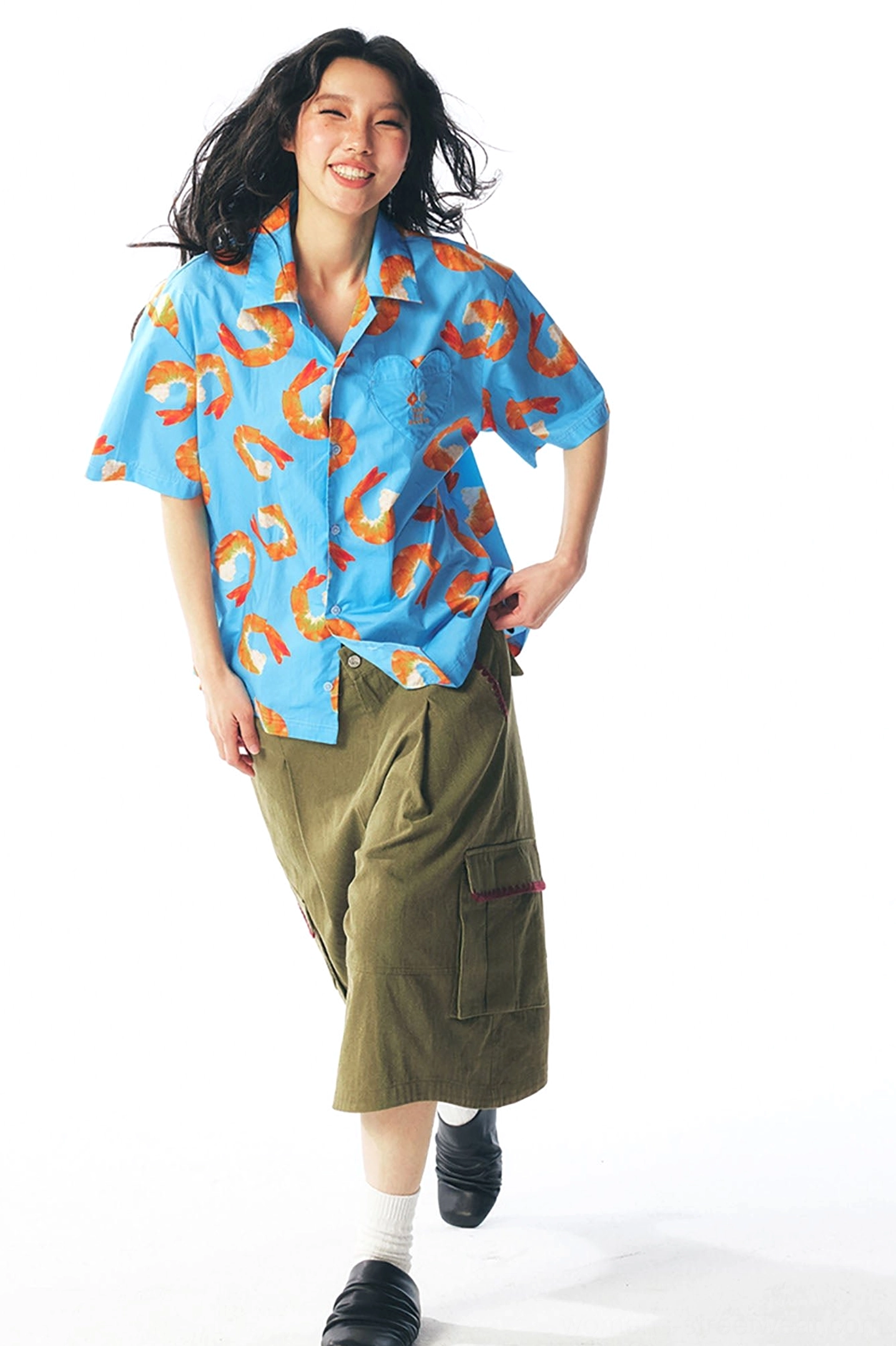 Front styling view of sky blue shrimp printed button-down shirt with short sleeves and olive wide-leg cropped pants