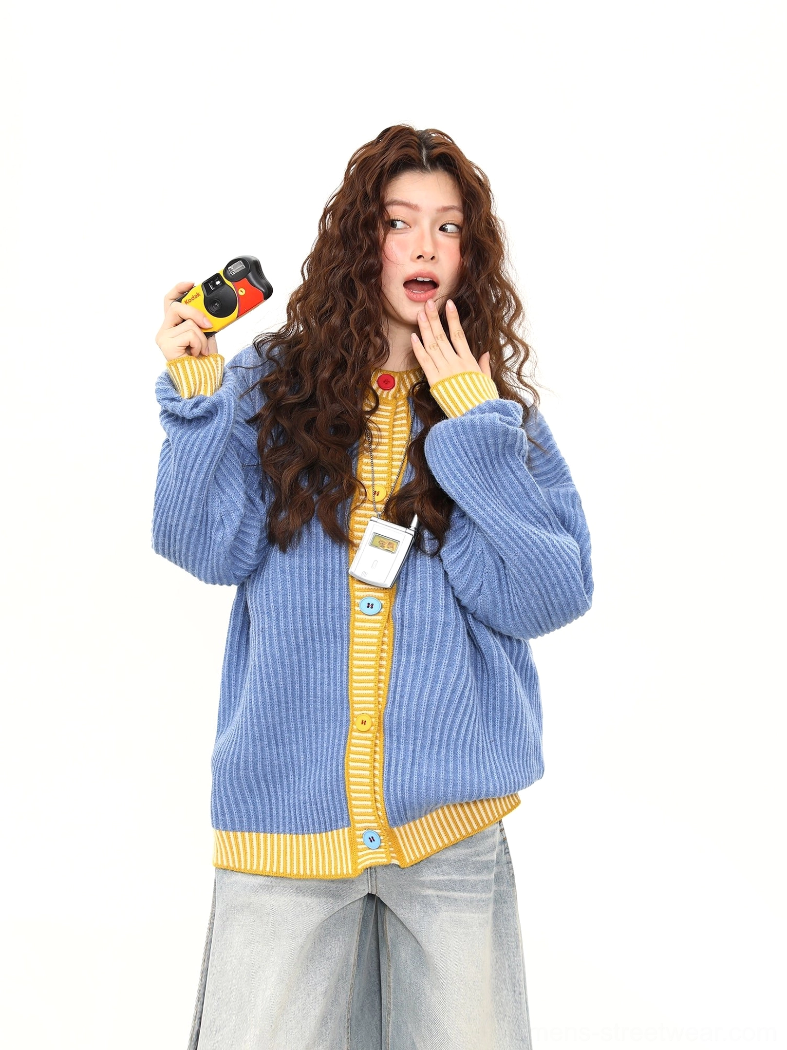 Sky blue ribbed cardigan with yellow striped details and front buttons styled with a vintage film camera