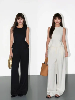 Black and apricot sleeveless peplum top with high-waist wide-leg trousers shown in a minimalist studio