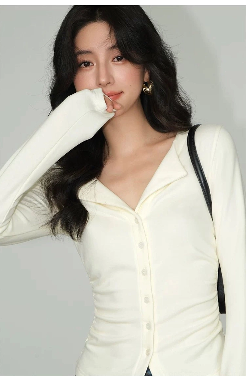 Light apricot slim-fit button-front knit cardigan top with structured notched lapel collar and feminine fitted silhouette