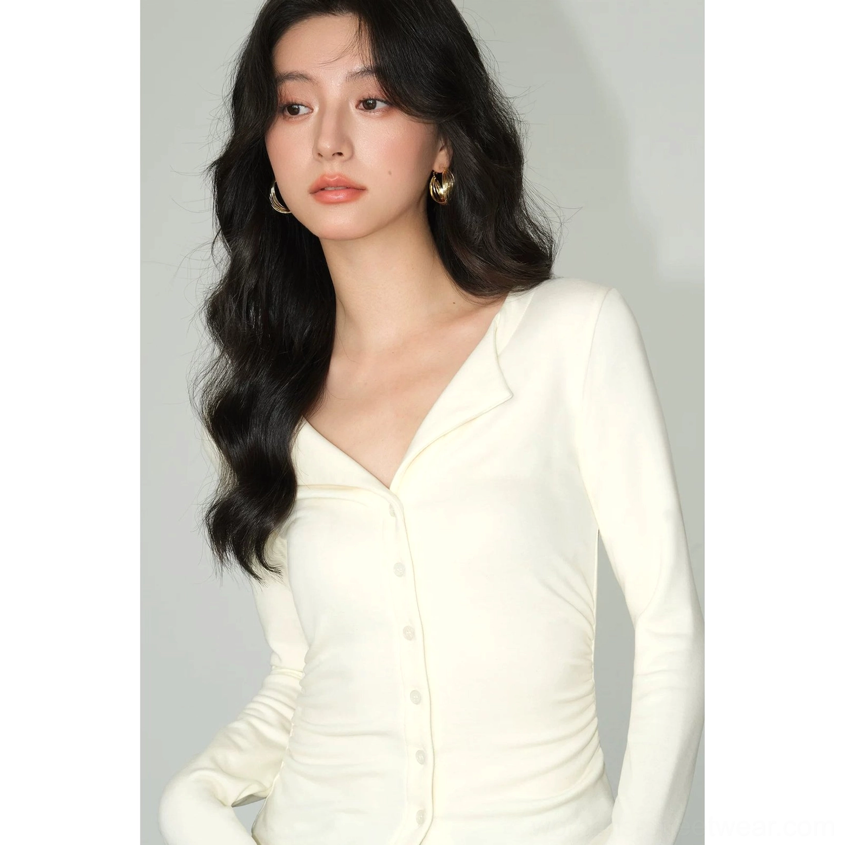 Light apricot slim fit button-front knit cardigan top with sculpted waist and notched lapel collar
