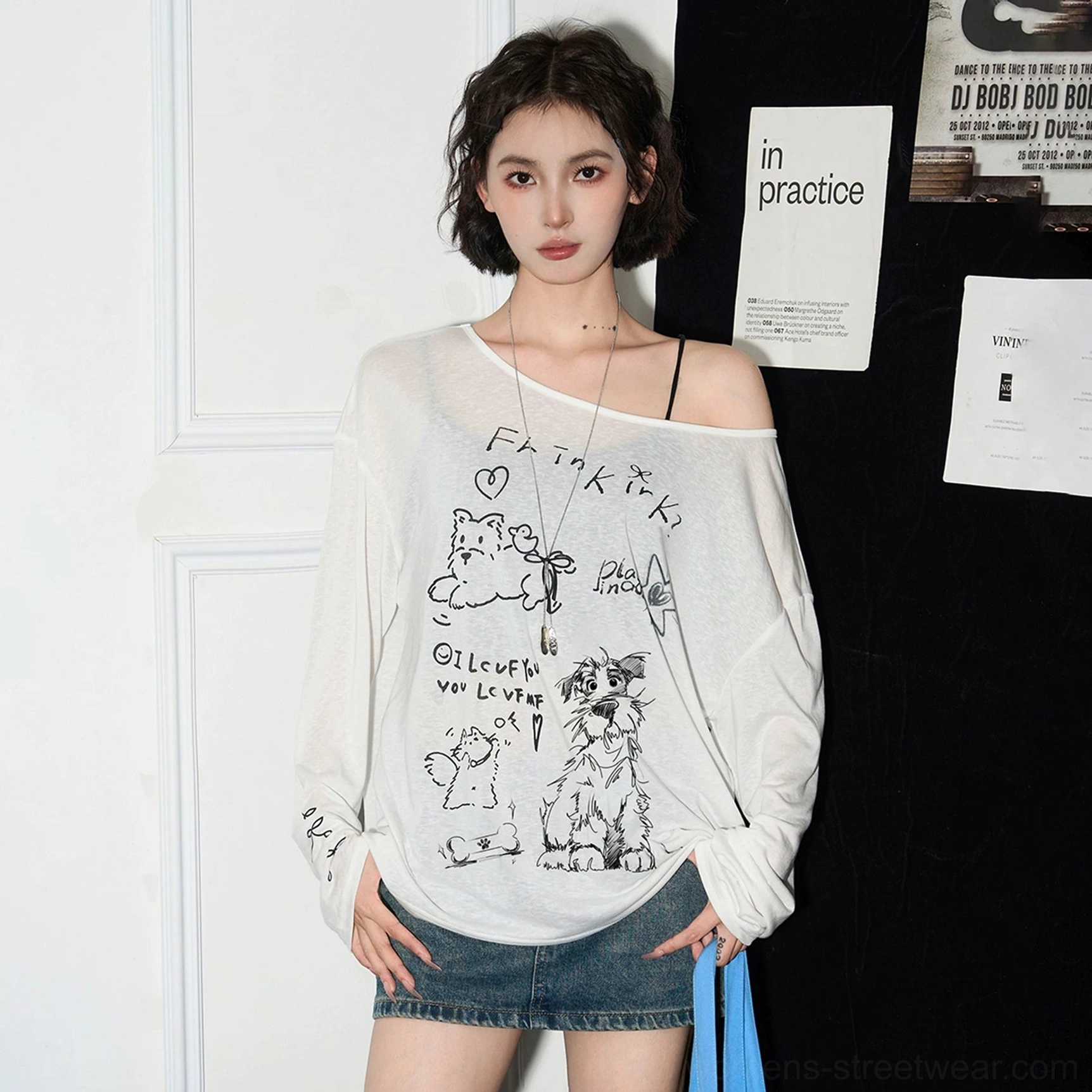 Close front view of slouchy off-shoulder sheer blouse with hand-drawn cat cartoon and typography graphic print