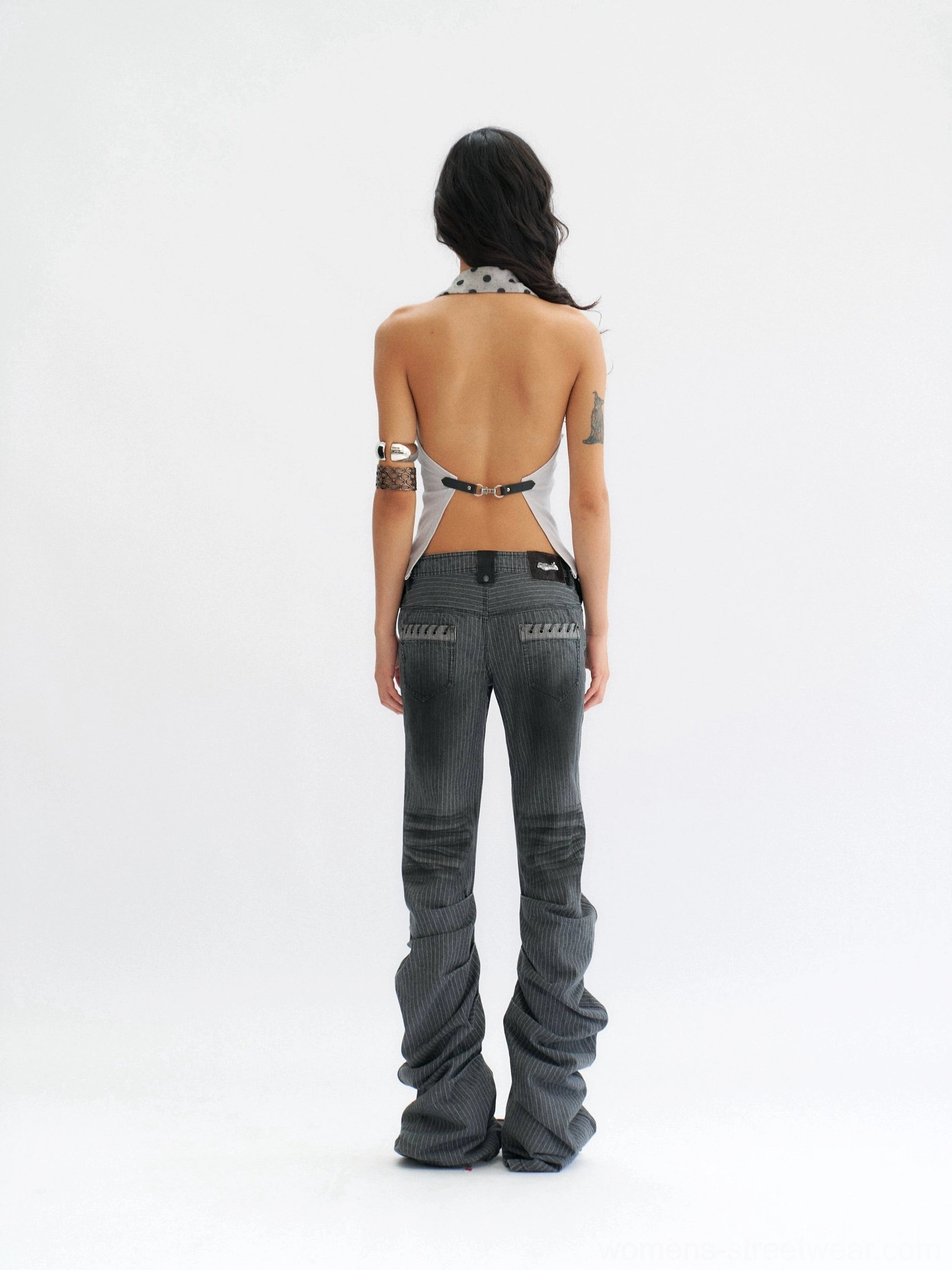 Rear view showing the open back, adjustable buckle strap, and polka dot halter trim on the smoke blue-gray streetwear top