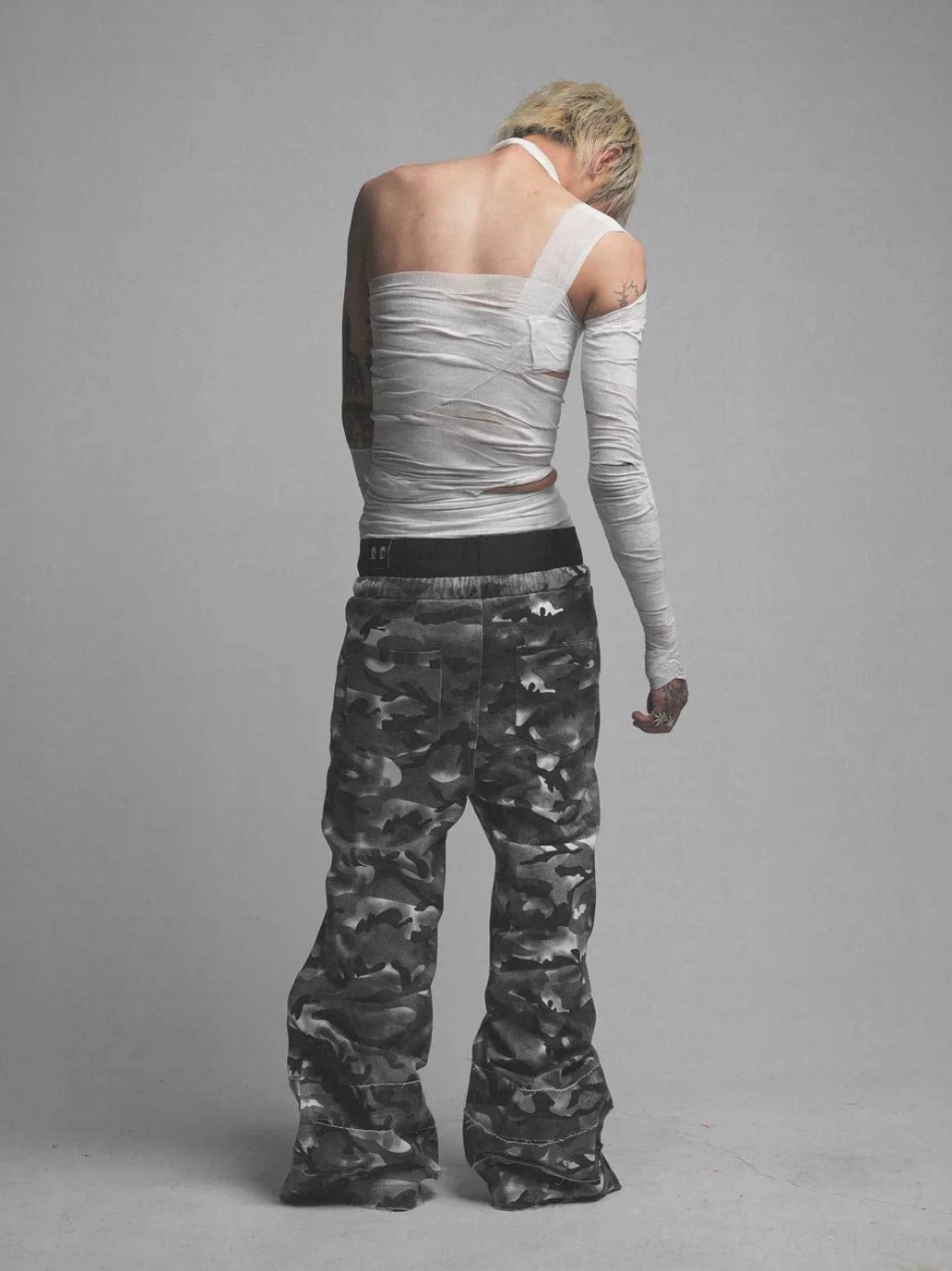 Smoke camo double waistband wide leg streetwear pants styled in an oversized urban outfit with layered accessories