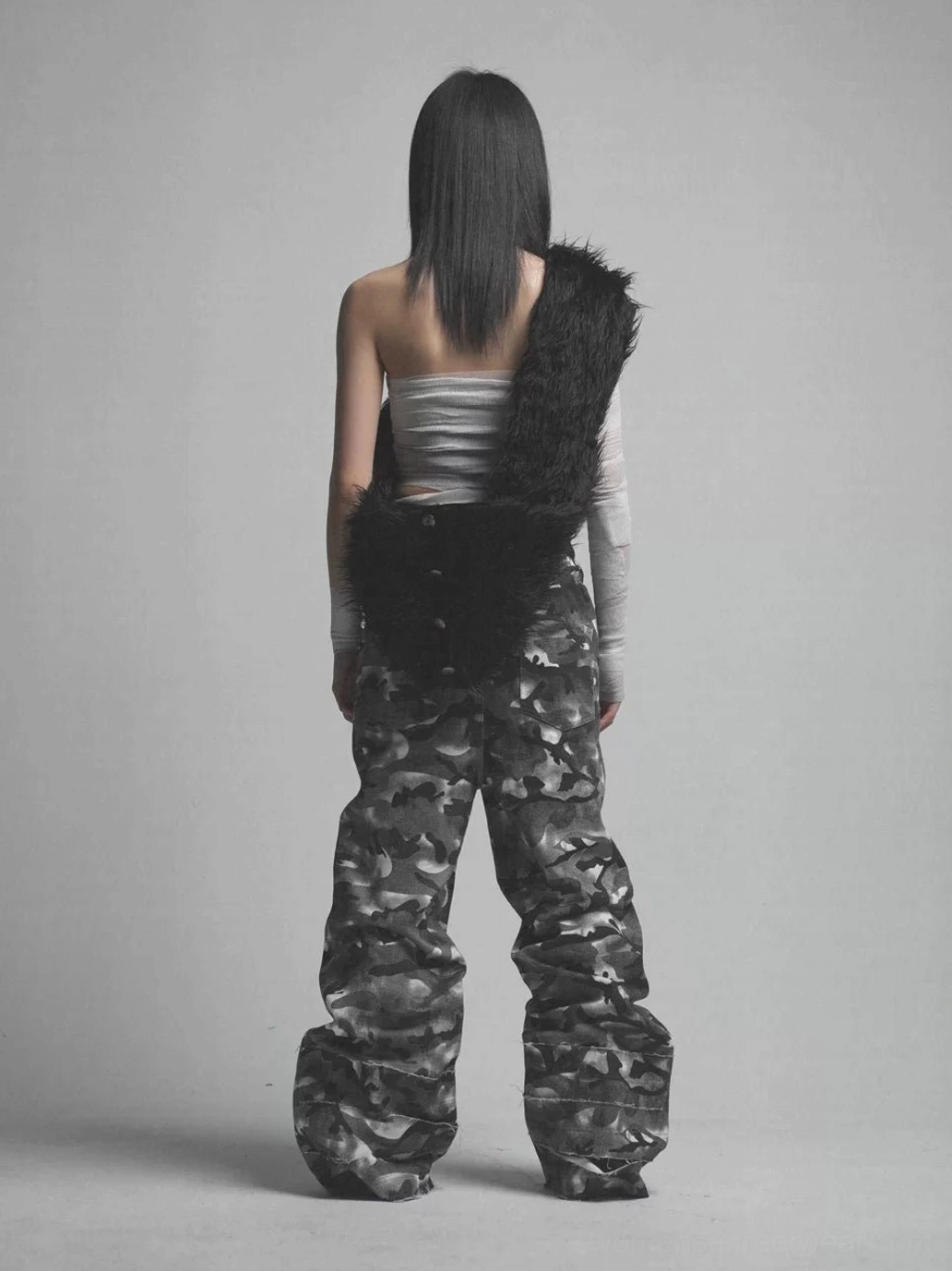 Rear studio view of oversized smoke camo streetwear trousers with loose stacked legs and contrast layered waistband