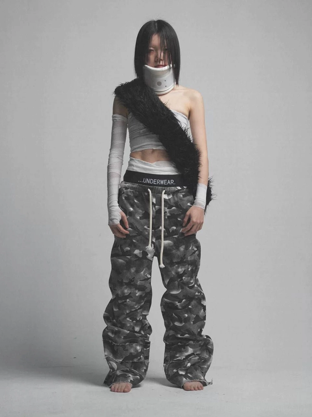 Front studio view of smoke camo wide leg streetwear pants featuring a visible black double waistband and oversized stacked silhouette