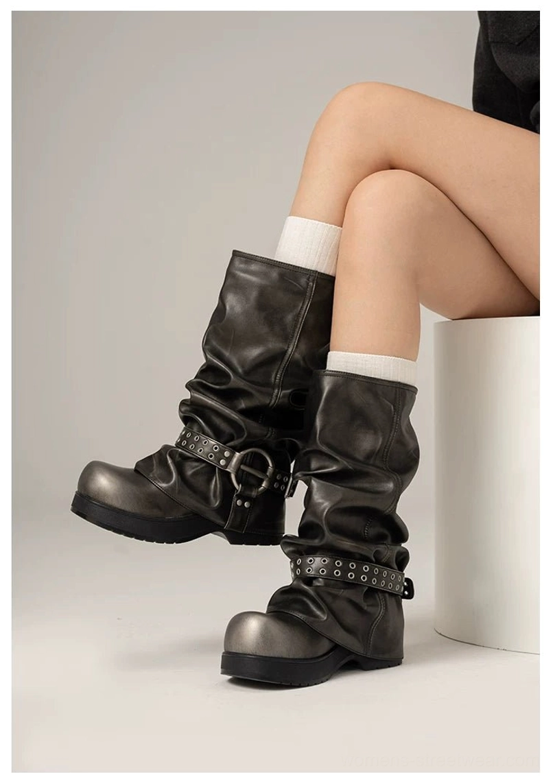 Smokestack slouch biker boots close side view showing natural shaft folds metal buckle and rivet ankle strap on thick platform sole