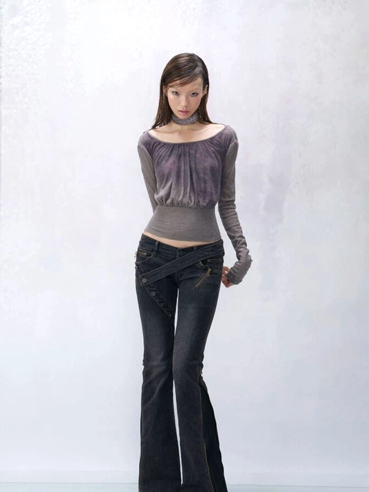 Smoky amethyst ruched halter knit top worn with dark flared jeans, featuring grey purple gradient fabric, cold shoulders, long puff sleeves, and cropped ribbed waist