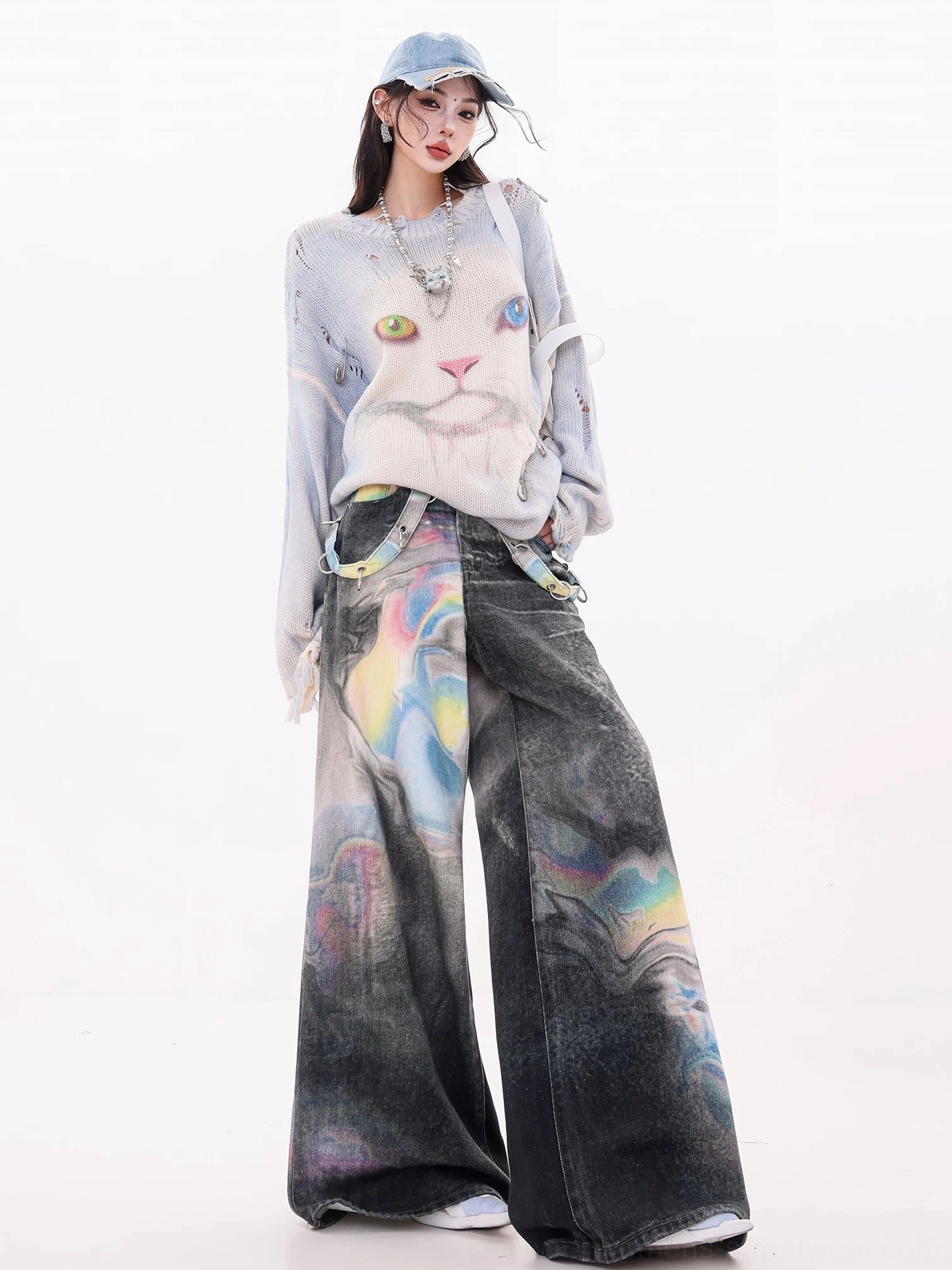 Three-quarter front view of smoky black gradient wash wide-leg jeans with iridescent watercolor print and coordinated denim cap styling