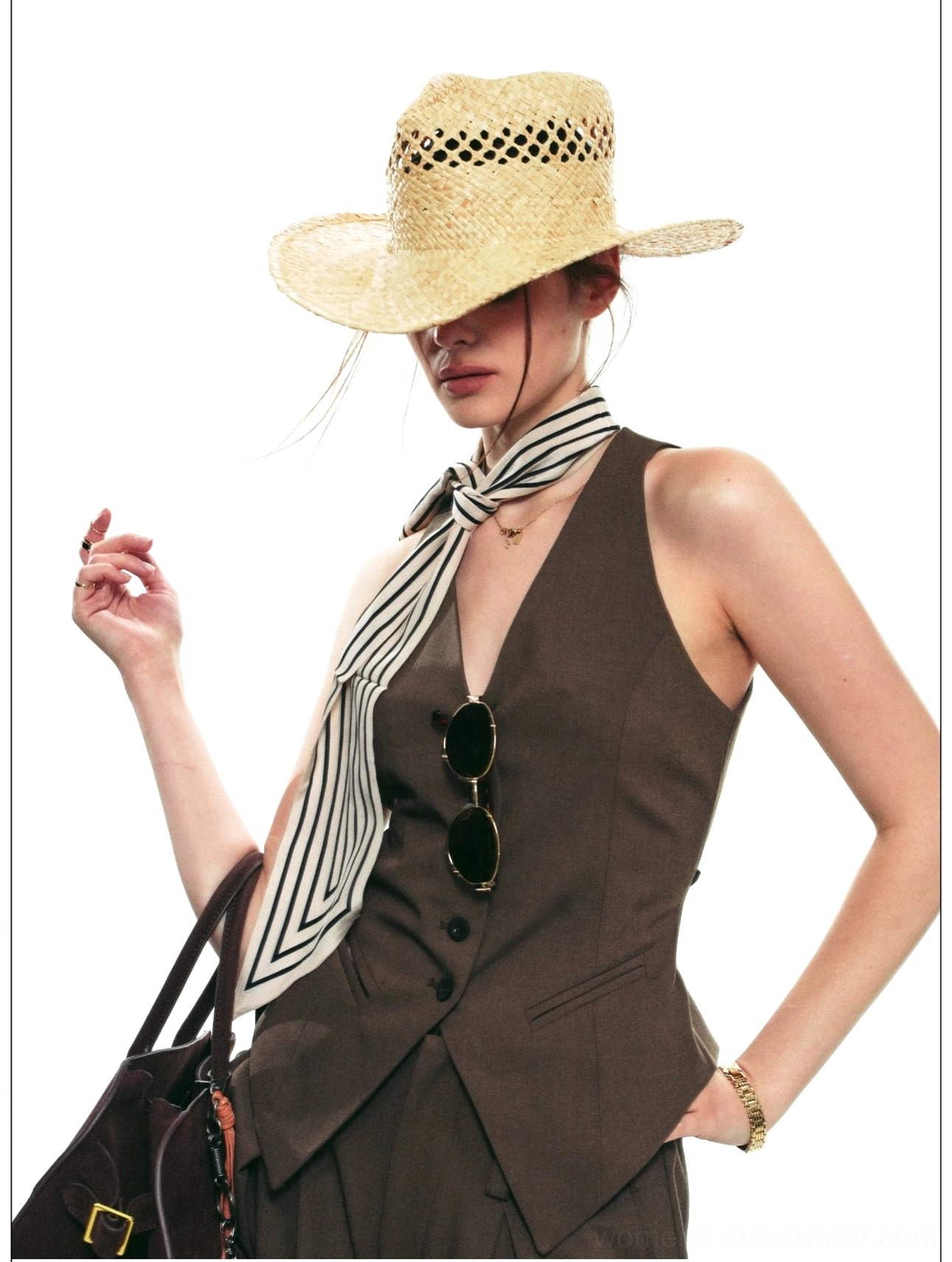 Close-up of smoky brown tailored halter vest with V-neckline, front buttons, sunglasses, and streetwear styling