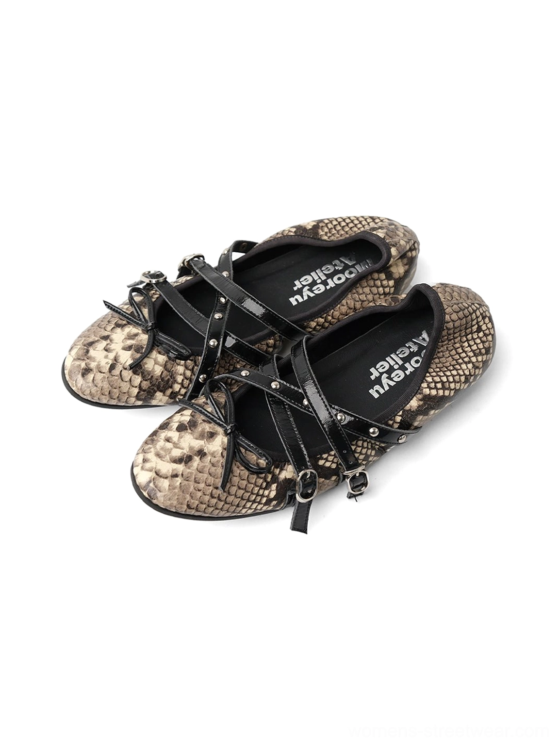 Front overhead product view of snakeskin cross-strap ballet flats with black bow straps and adjustable buckles