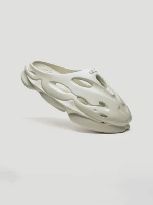 Snow Lion off-white perforated platform clog side view showing open-back slip-on silhouette and thick cushioned platform sole