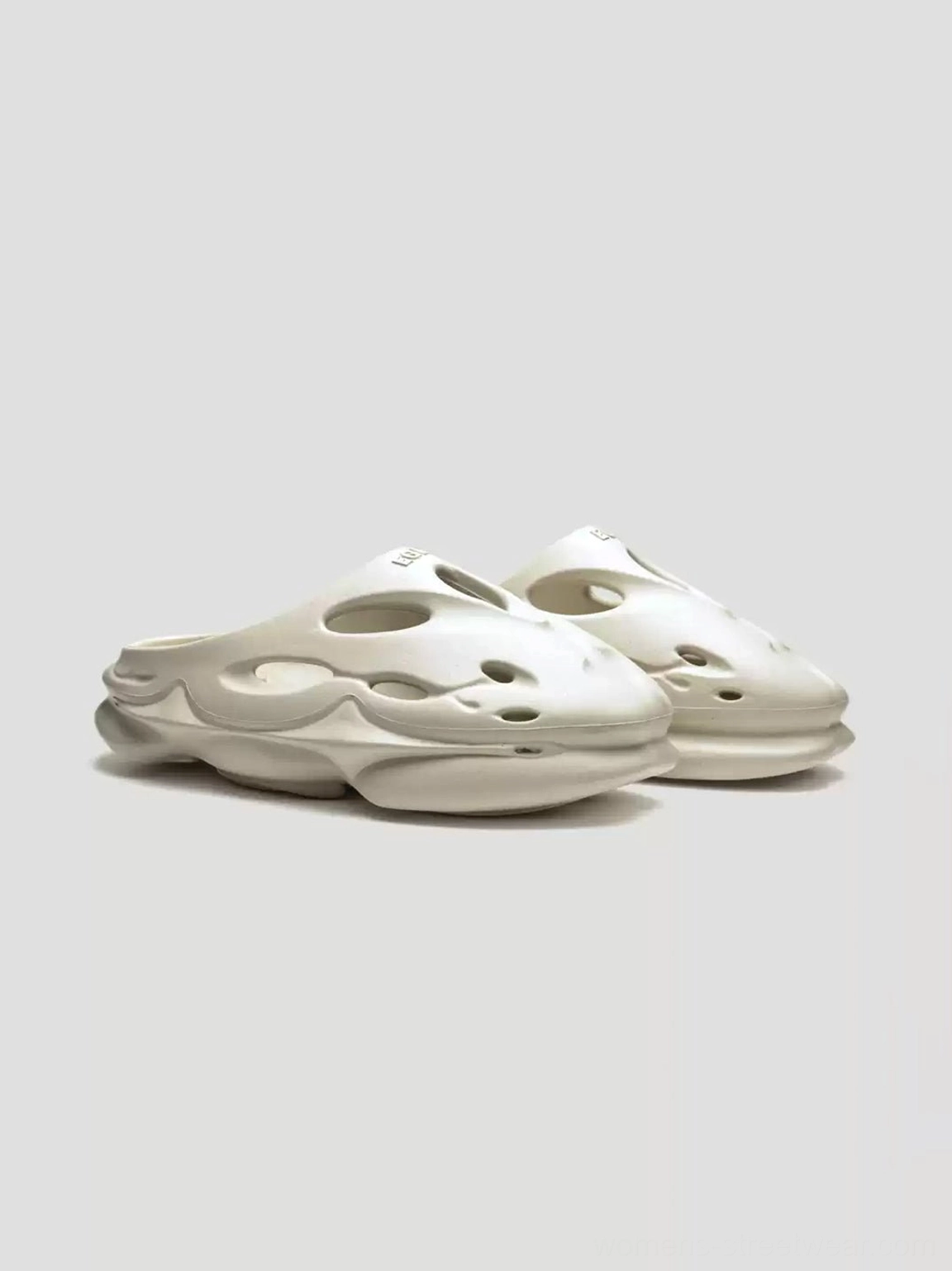 Snow Lion off-white perforated platform clogs front flat lay showing ventilated wave-cut upper and low-back mule design
