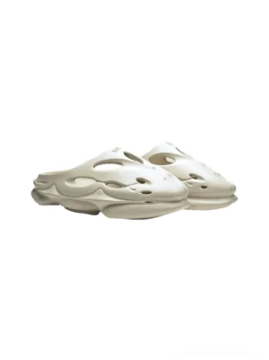 Snow Lion off-white perforated platform clogs in front three-quarter pair view with sculptural wave cutouts and chunky sole