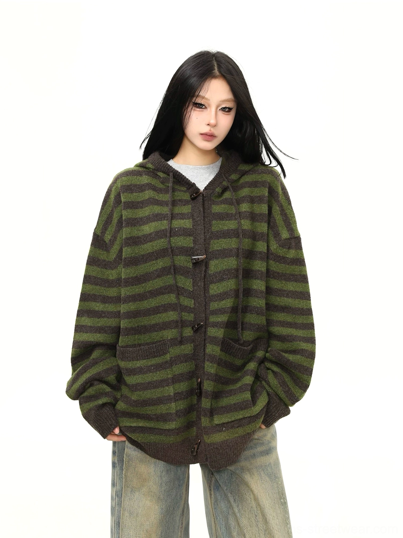 Close-up of soft fuzzy knit texture, dark toggle closures, ribbed details, and coordinated stripes on an oversized streetwear cardigan