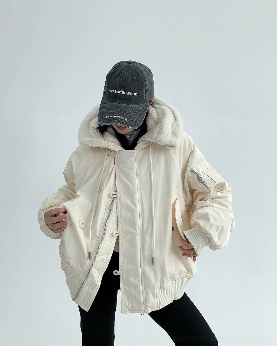 Soft off-white sherpa-lined bomber jacket with cocoon silhouette, roomy sleeves, and everyday winter layering appeal