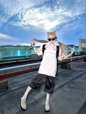 Female model wearing khaki solar buckle suede comfort slides with a sporty streetwear outfit on an urban rooftop
