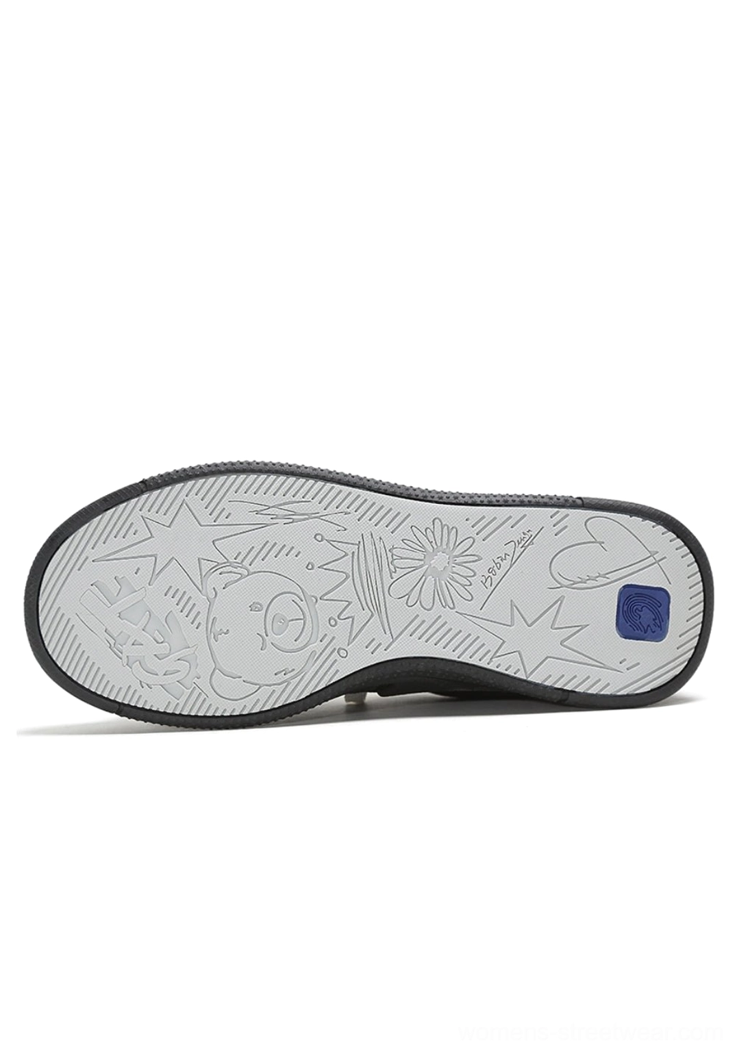 Bottom view of the textured rubber outsole on a black and white solar star applique court sneaker
