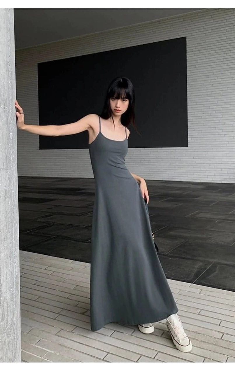Solid color maxi dress with slim spaghetti straps and a smooth contemporary Korean fashion silhouette