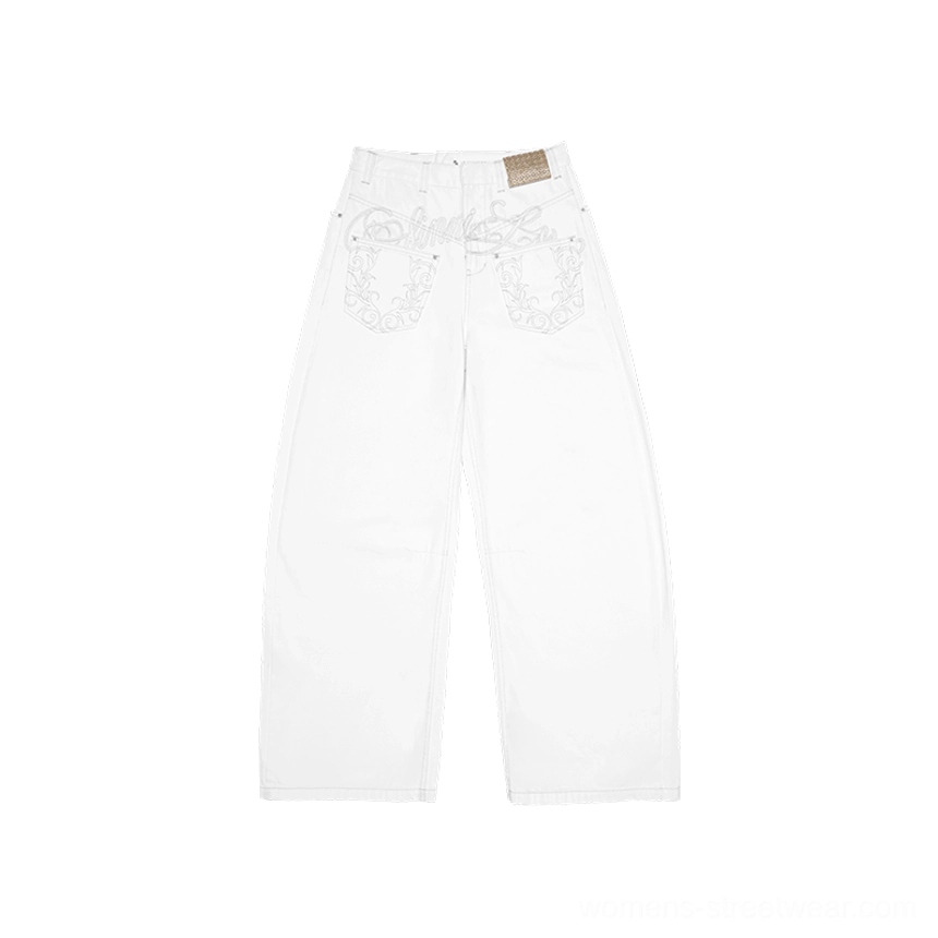 Flat lay front view of solid white wide-leg denim pants with embroidered front pocket decorations and a clean minimalist streetwear design