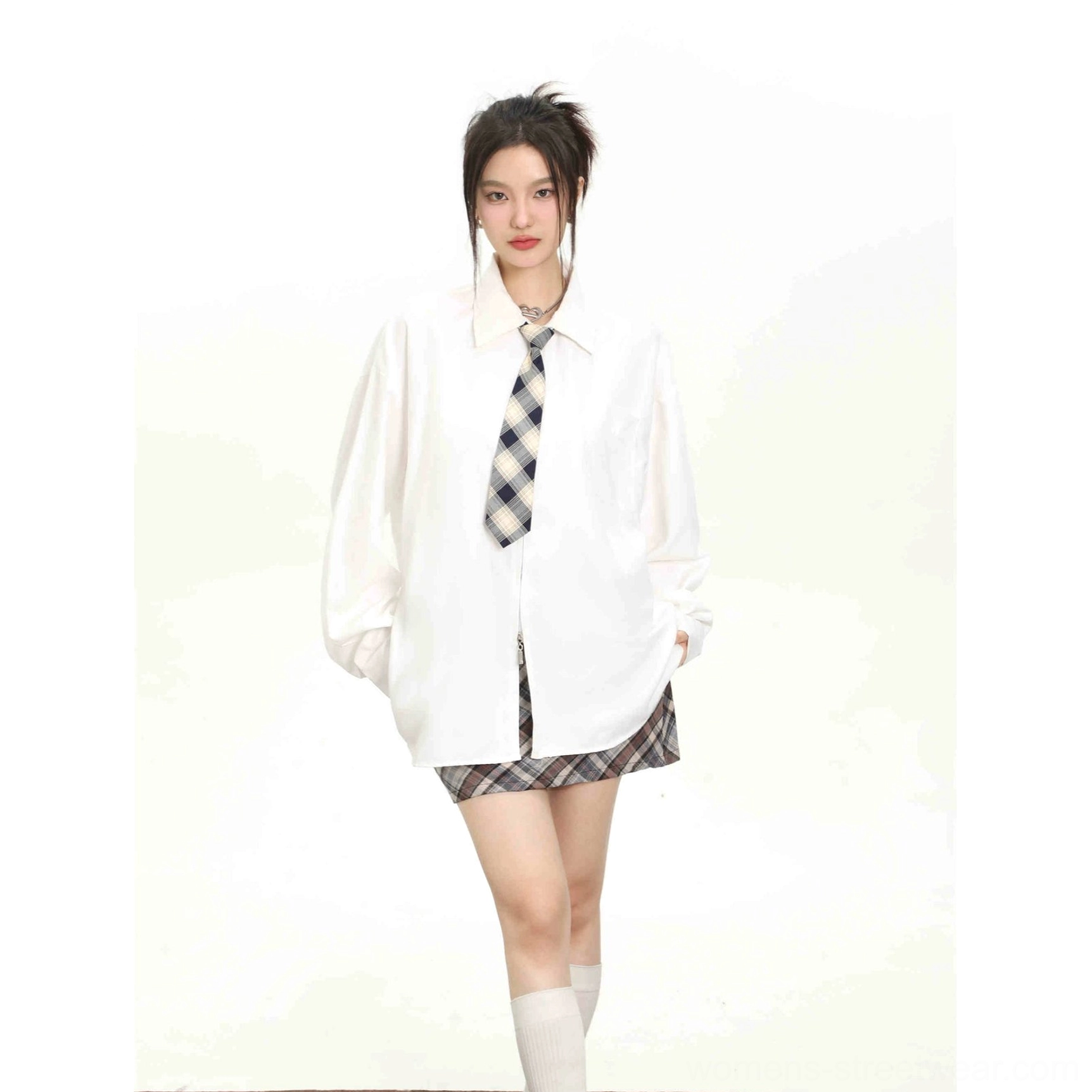Solid white women's long sleeve button-up shirt styled with a checkered tie plaid mini skirt and white socks