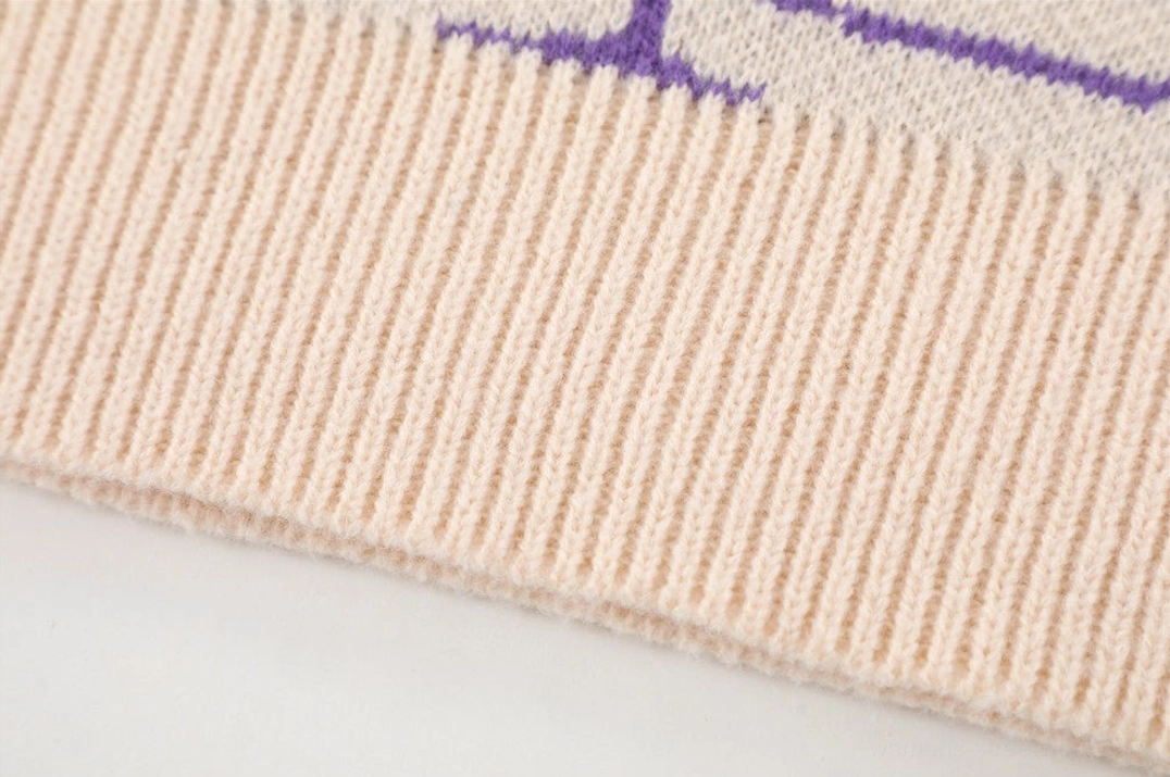 Cream ribbed hem detail on purple spider web jacquard streetwear knit sweater
