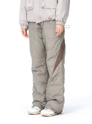Front view of taupe gray and dark brown spliced padded streetwear track pants with a relaxed wide-leg fit