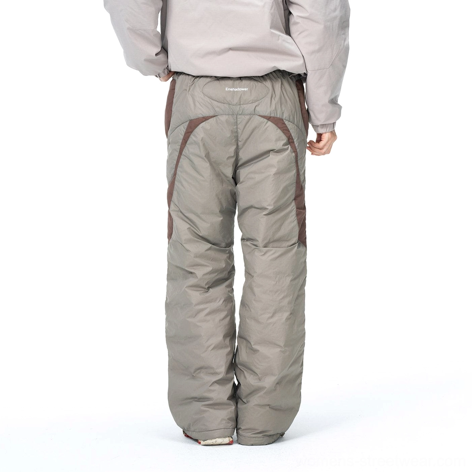 Rear view of wide-leg padded track pants showing curved dark brown back panels and quilted down-filled construction