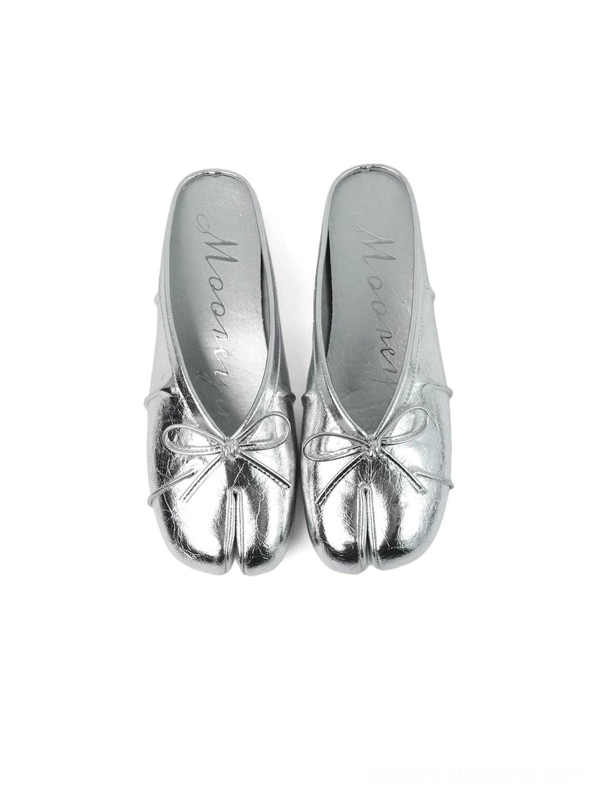 Close product view of split tabi toe mules with delicate bow accents and smooth contemporary finish