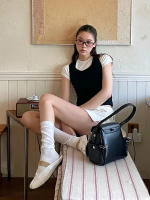 Split-toe open-back mule flats styled with white socks in a retro cafe streetwear outfit