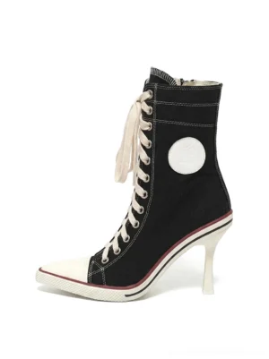Black sporty 8cm canvas heeled boot shown in left profile with lace-up mid-calf shaft white rubber toe cap and contrasting streetwear details