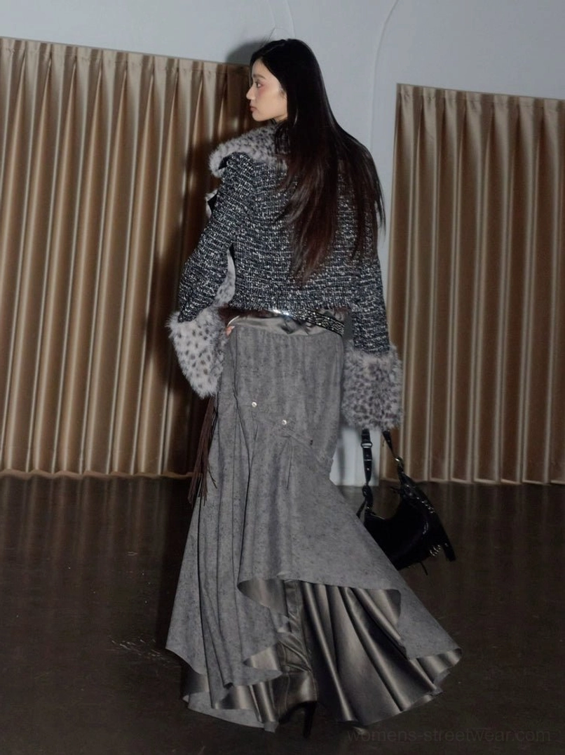 Back view of a spotted faux fur cropped jacket with dark textured tweed sleeves and bold streetwear styling