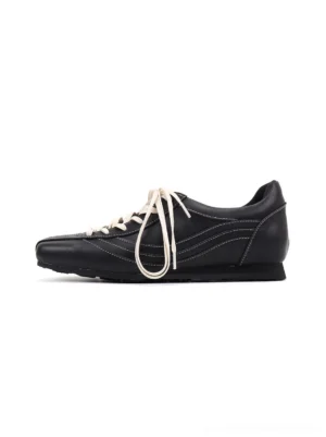 Left side profile of square-toe black leather retro trainers with off-white elongated laces and slim foam rubber sole