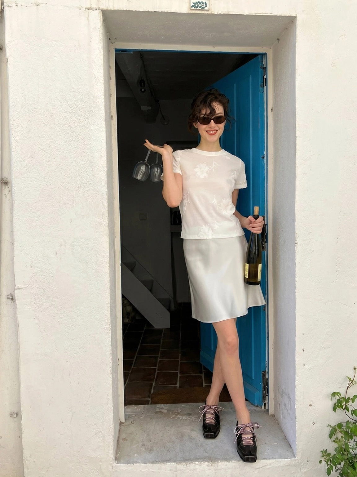 Full body street style outfit featuring black square toe ribbon lace-up ballet trainer sneakers at a doorway