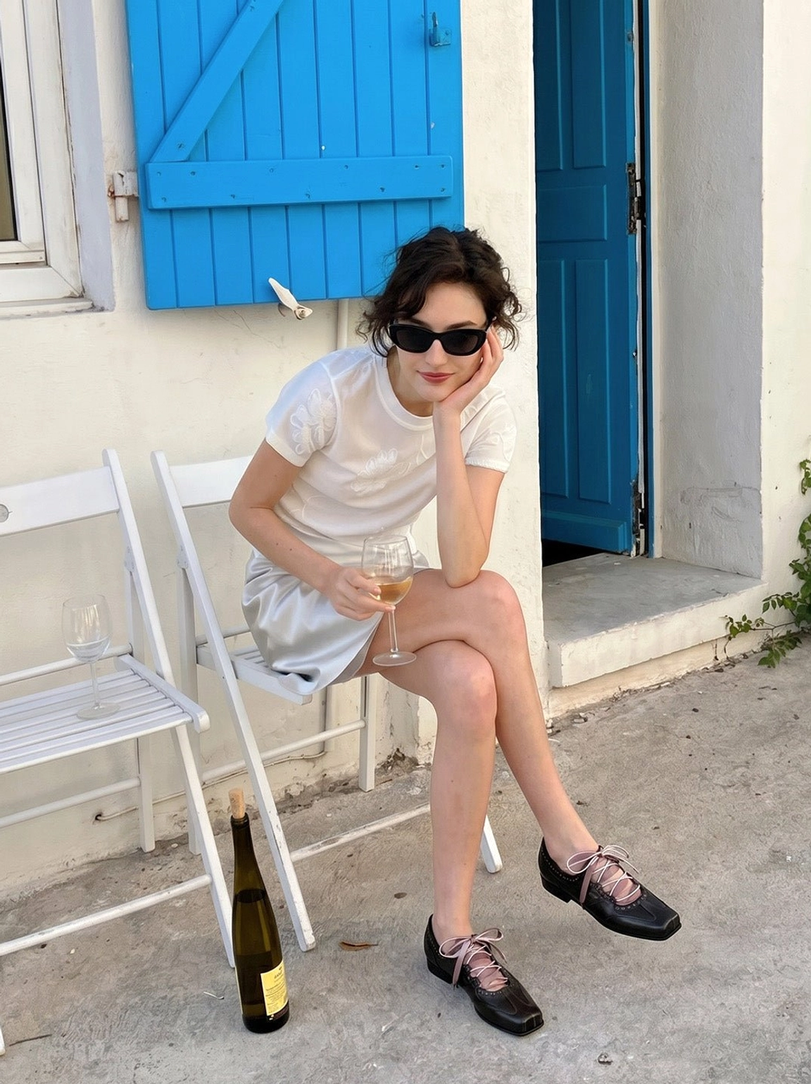 Model wearing black square toe satin ribbon ballet trainer sneakers with a satin skirt in a retro street setting