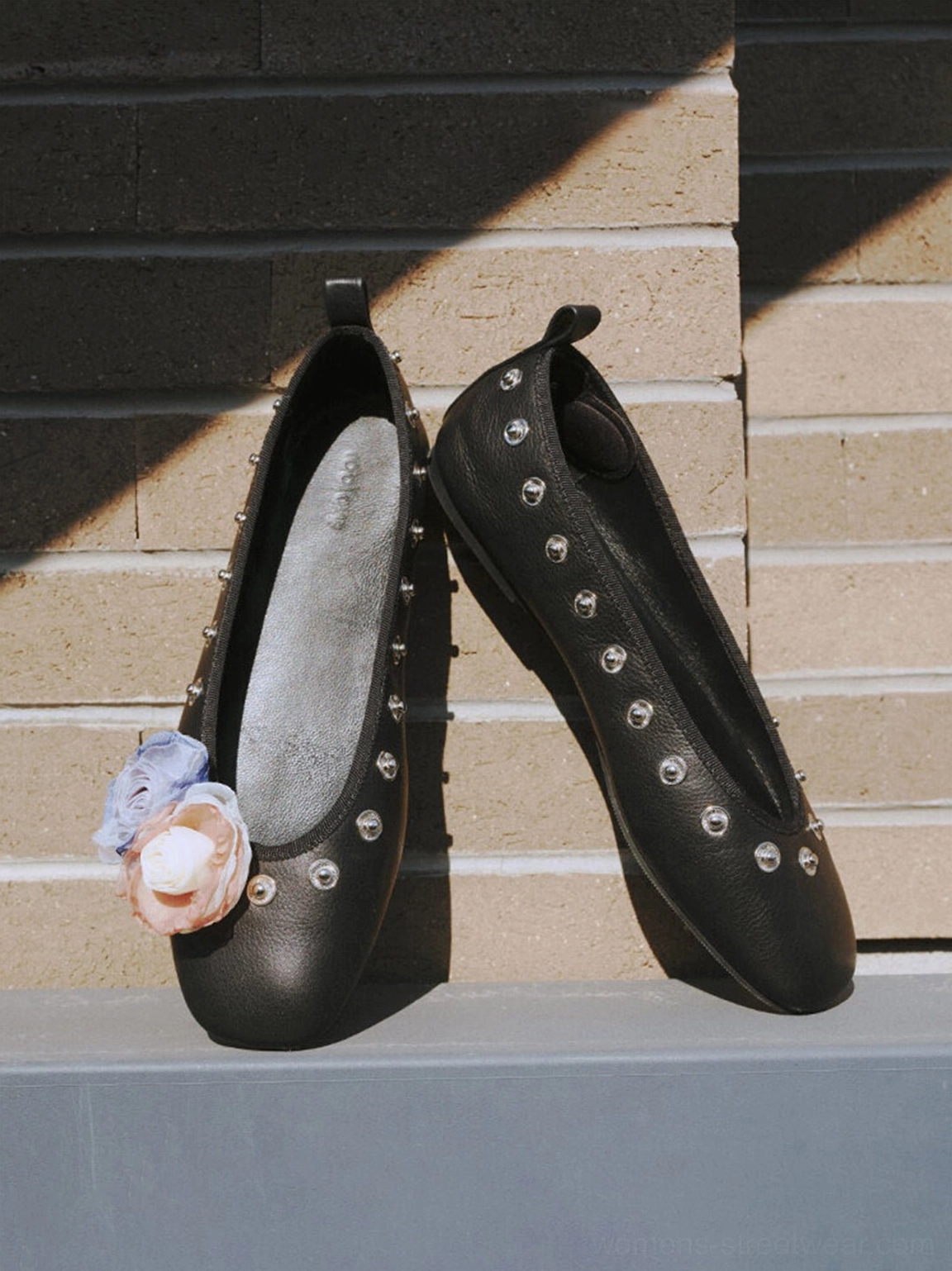 Square-toe studded floral flats featuring decorative flowers and low-profile ballet silhouette