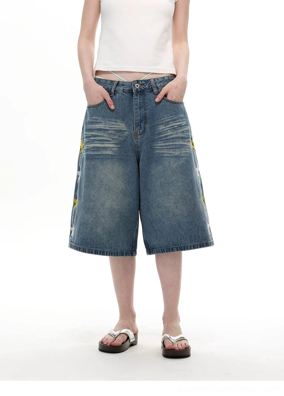 Front view of light wash wide-leg denim knee shorts with oversized loose streetwear silhouette
