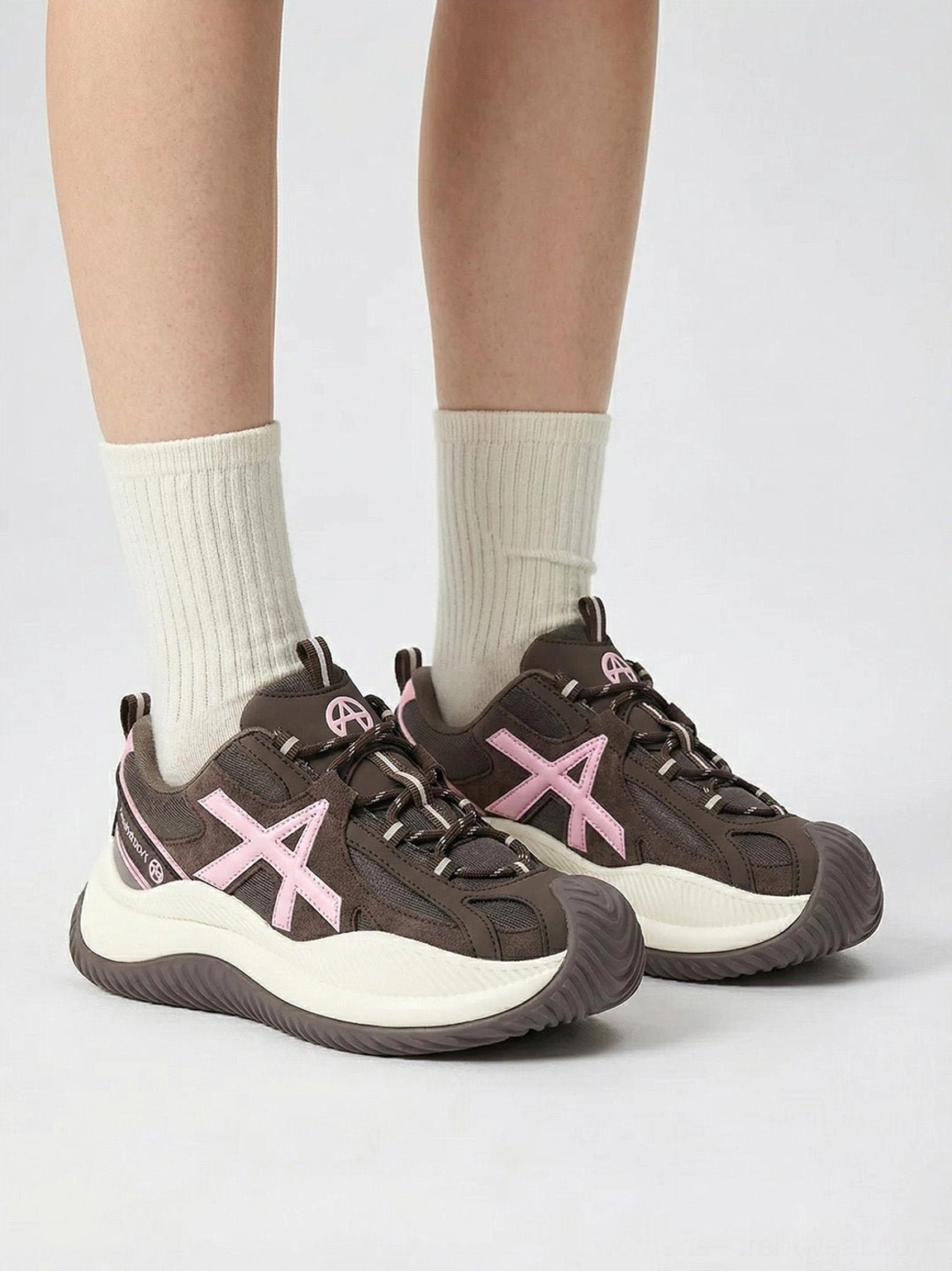 Chunky sneakers heel counter detail showcasing brand lettering construction quality reinforced ankle support area