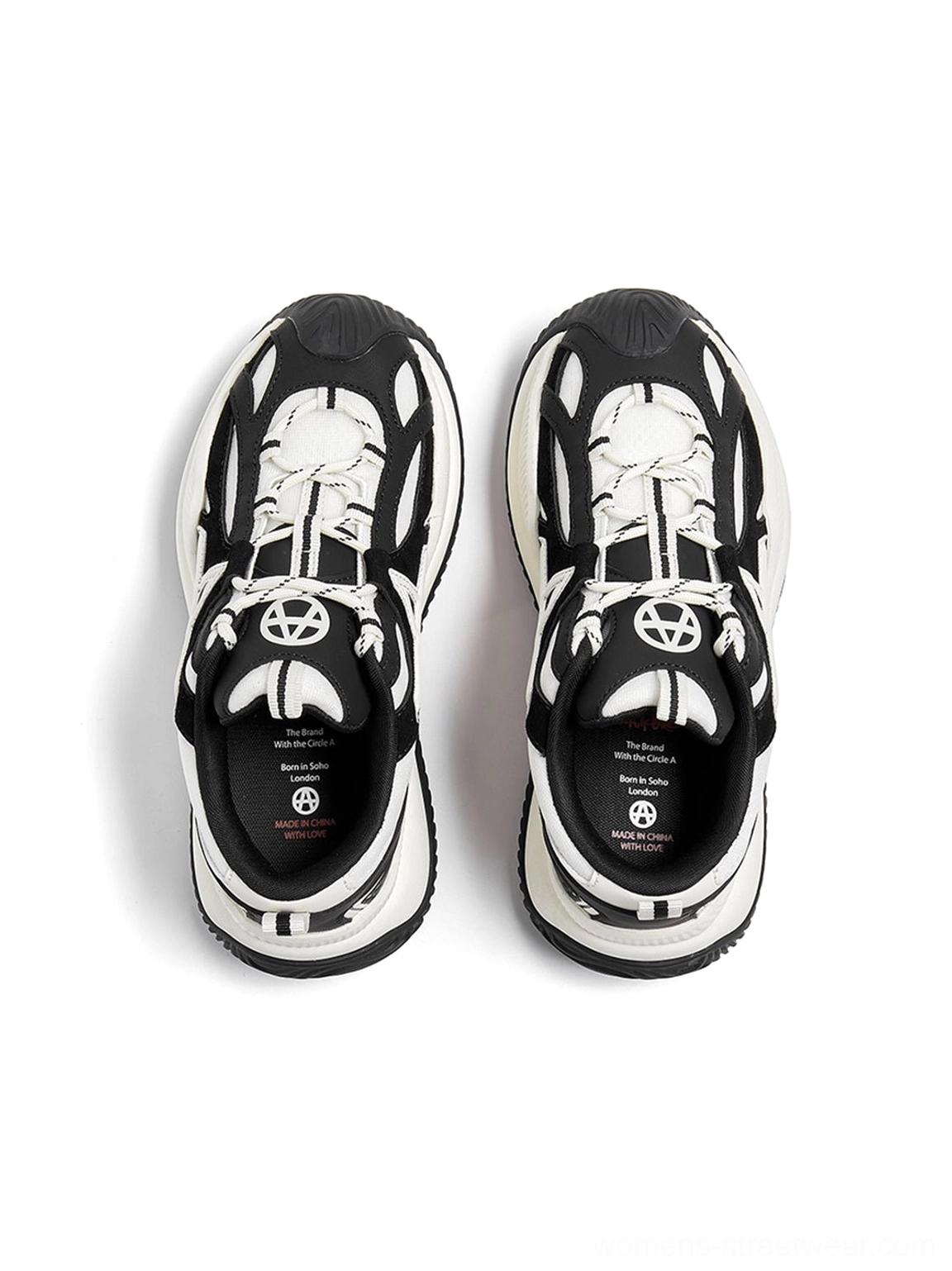 Chunky wave-sole sneakers detail shot emphasizing star-shaped lacing system oversized star perforations and mesh upper construction