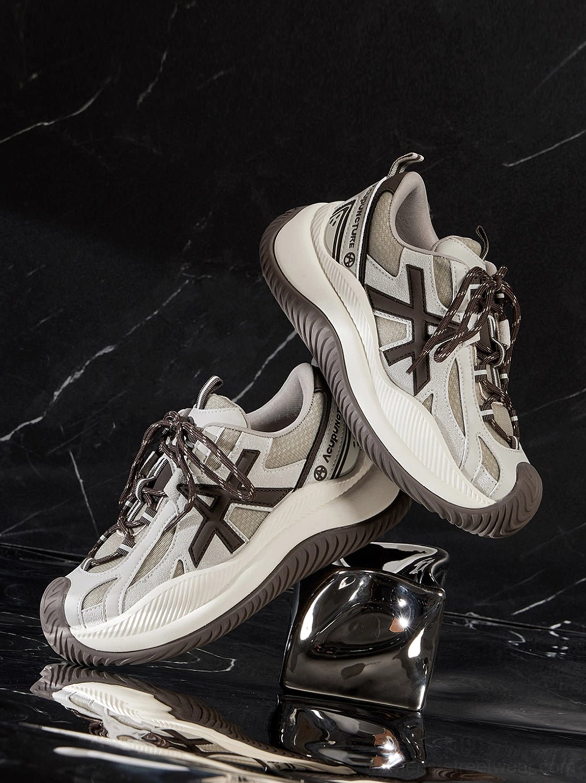 Lateral side view of chunky sneakers highlighting wave sole curve graphic panels layered construction design elements