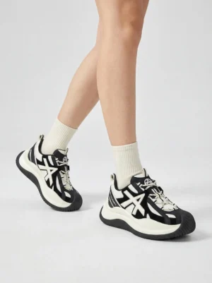 Female model wearing chunky wave-sole sneakers with white crew socks demonstrating platform sole thickness and lace-up closure system