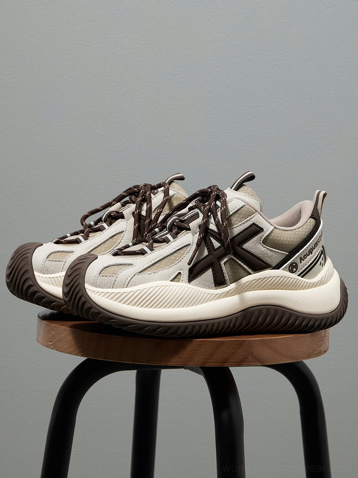 Quarter view of wave-sole chunky sneakers showing upper mesh construction color blocking transition geometric precision