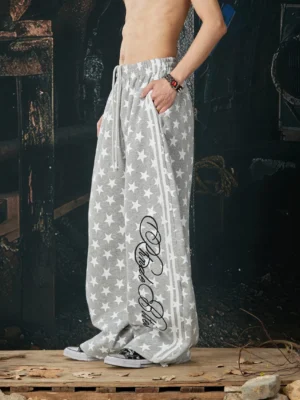 Heather gray star print wide-leg streetwear track pants side view with elastic drawstring waist and script leg detail