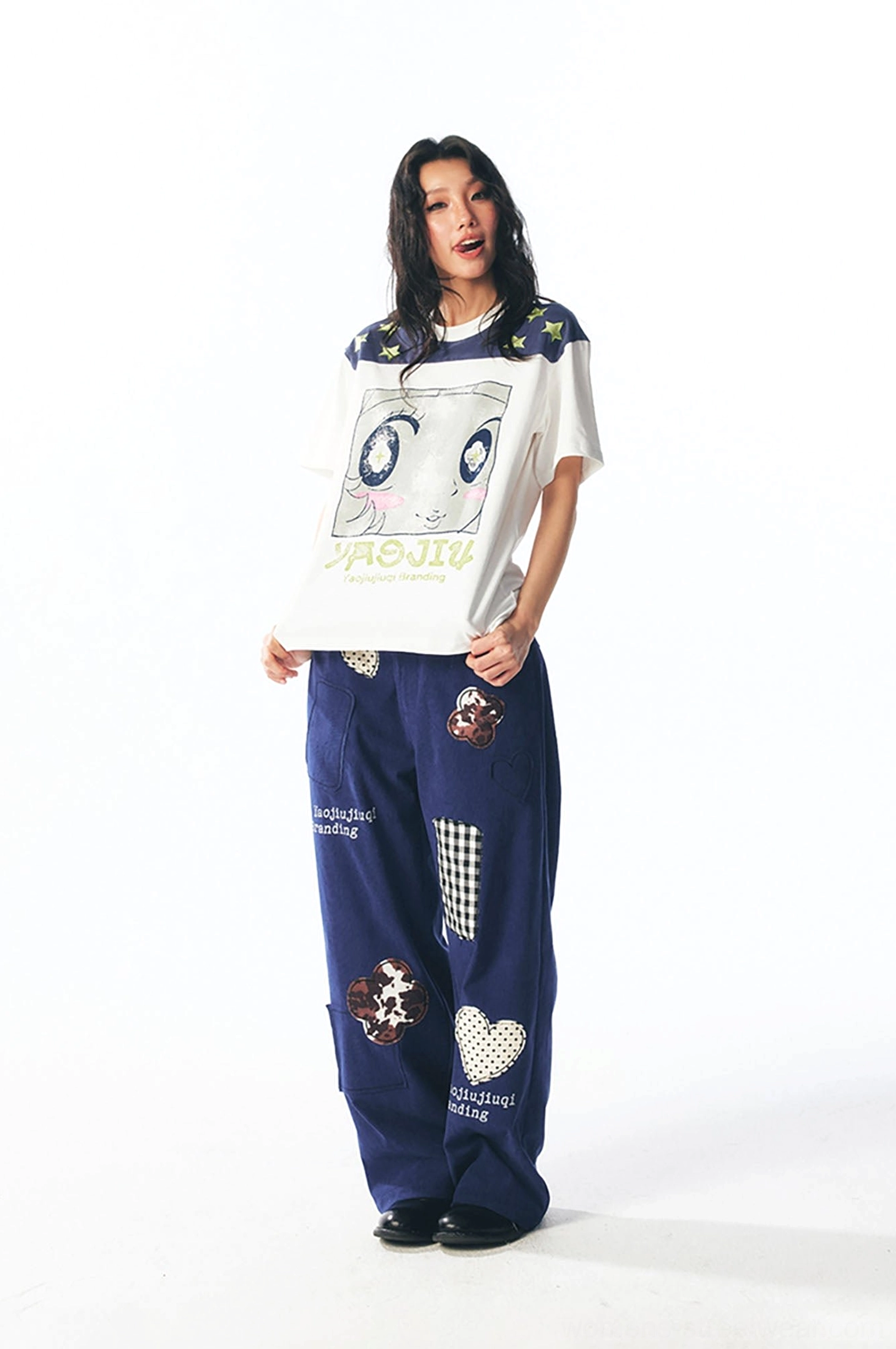 Side profile of female model wearing star shoulder cartoon graphic streetwear t-shirt