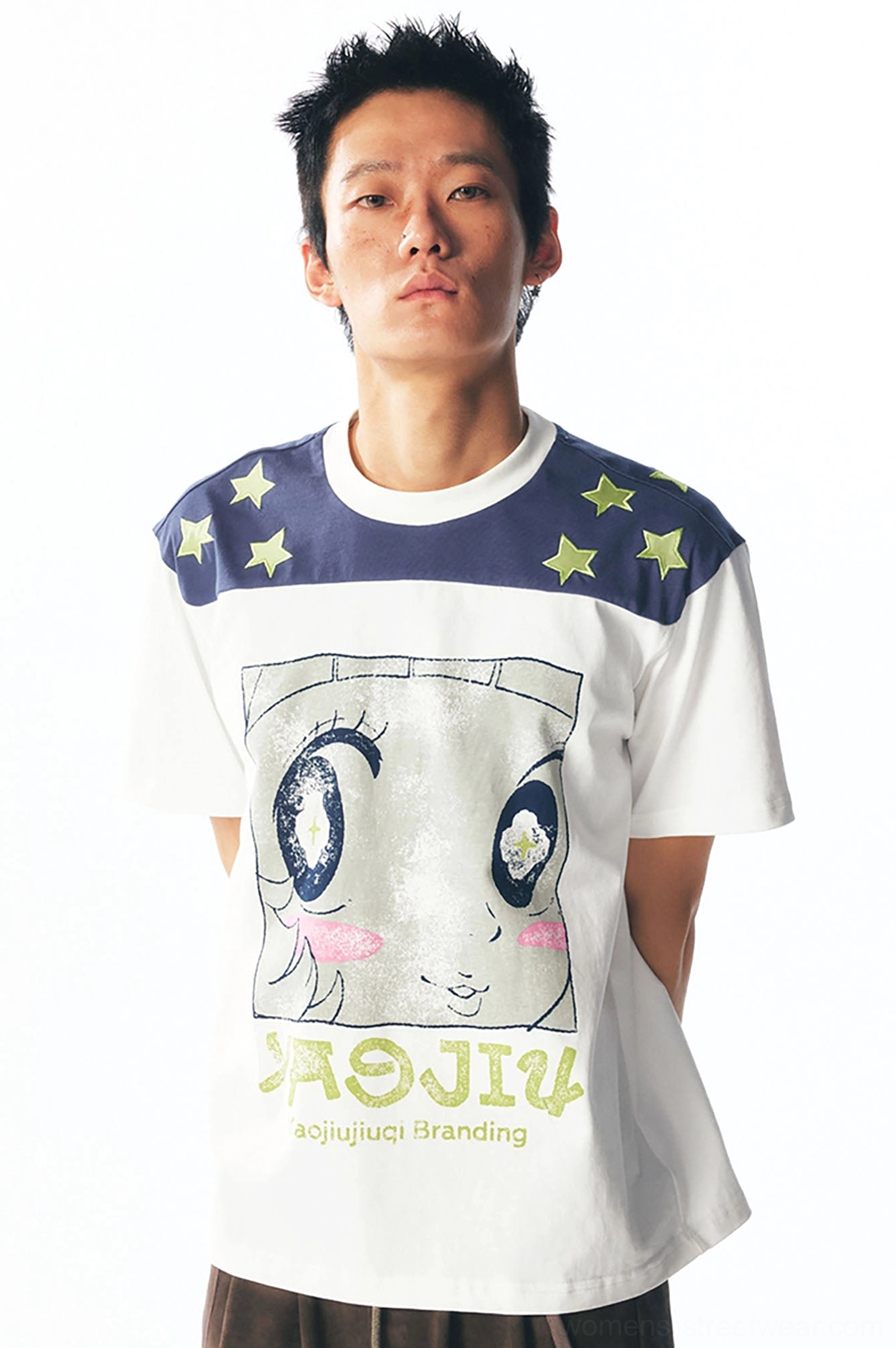 Flat lay of white cartoon graphic unisex streetwear tee with navy yellow star-print shoulder yoke